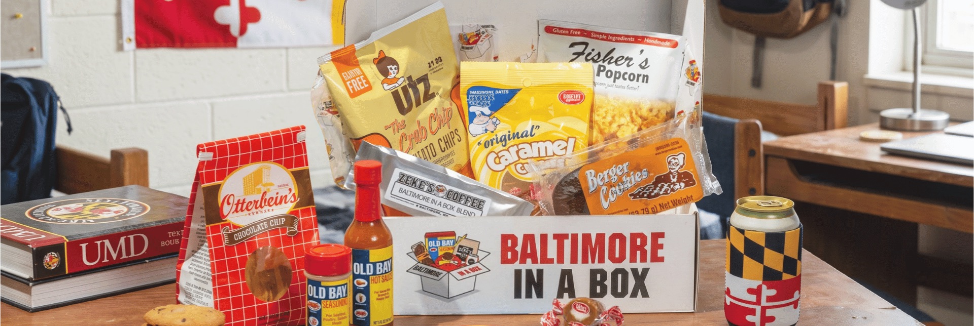 An open Baltimore in a Box filled with Utz Crab Chips, Berger Cookies, Fisher’s Popcorn, Old Bay and more